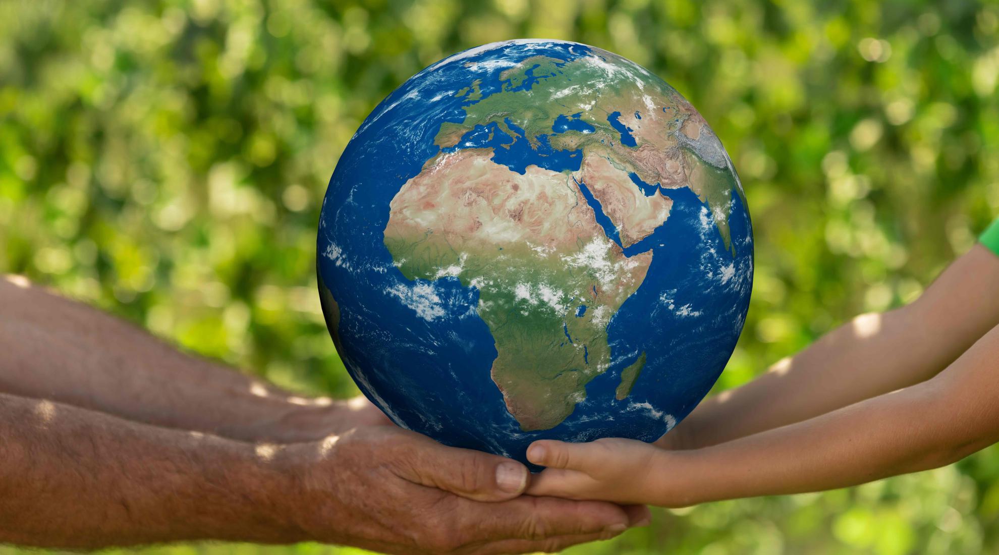 Holding an earth globe in the hand