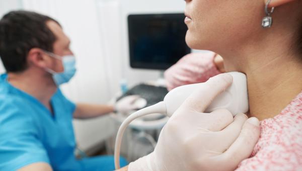 young woman undergoing an examination of thyroid