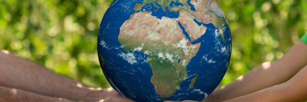 Holding an earth globe in the hand